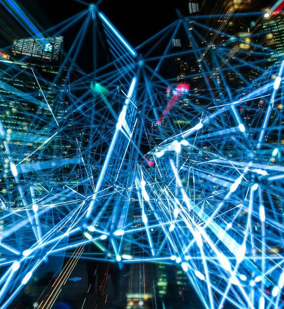 Night view of modern high rise building with an overlay of illuminated interconnected lines Night view of modern high rise building with an overlay of illuminated interconnected lines